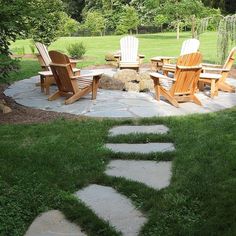 a stone patio with lawn chairs and stepping stones