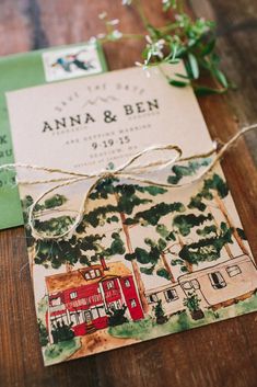 the wedding stationery is tied up with twine and some greenery on top