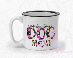 a white coffee mug with the words kinda busy being a dog mom