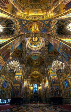 the inside of an ornately decorated church with gold and blue paint on the ceiling