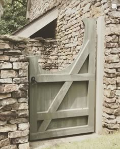 an old stone building with a wooden gate