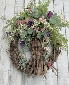 a wreath made out of branches and flowers