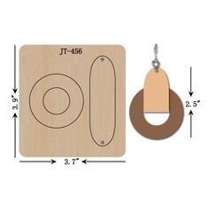 a wooden keychain with an oval and circle design on the front, next to a