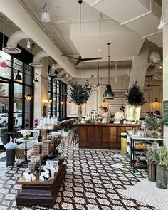 the interior of a restaurant with lots of tables and chairs in front of large windows