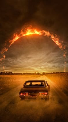 a car driving down a dirt road under a cloudy sky with an orange ring in the middle