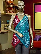 a mannequin wearing a colorful top in front of a tv