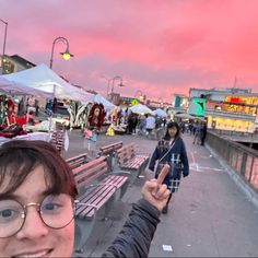 a woman taking a selfie at an outdoor market