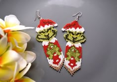 This beaded Grinch fringe earrings are made of seed beads, silver plated ear hooks, nylon thread, silicon plugs. All the color fit perfectly and give a mesmerizing look that fits Christmas holiday. Fringe earrings size: The full length of earrings with hook is 4.5 inches, the length of beaded part of earrings is 4 inches. Please contact me if you want these earrings in another size. Handmade item Length: 4.5 Inches; Beaded length: 4 Inches Materials: 11/0 Seed beads These earrings measure from t Christmas Beaded Earrings, Delica Earrings, Grinch Earrings, Party Fringe, Seed Beads Diy, Santa Earrings, Seed Bead Projects, Diy Seed Bead Earrings, Holiday Beading