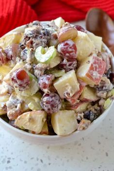 a white bowl filled with fruit salad on top of a table