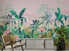 a living room with a plant wall mural