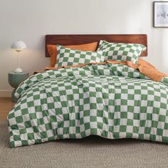 a green and white checkered comforter set on a bed