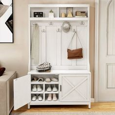 a white bench with shoes and purses on it next to a wall mounted coat rack