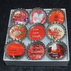 six bottle cap magnets with different sayings on them in a display case for sale