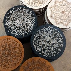 four wooden coasters with intricate designs on them sitting next to each other in a circle