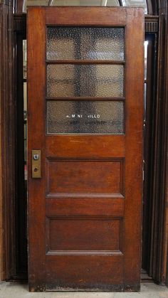 an old wooden door with glass inserts