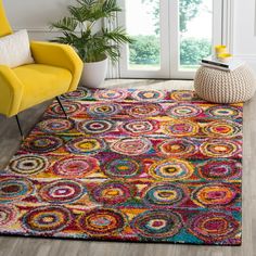 a brightly colored area rug in a living room