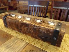 a wooden table topped with candles on top of it