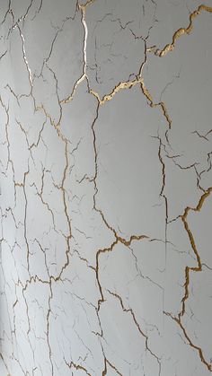 a white wall with gold paint on it