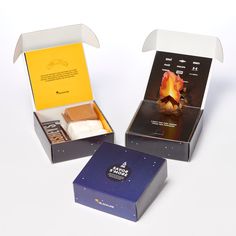 three boxes with different types of chocolates in them on a white surface, one opened and the other closed