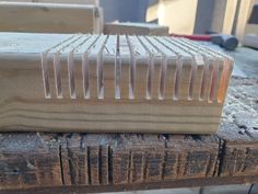 a wooden book sitting on top of a piece of wood