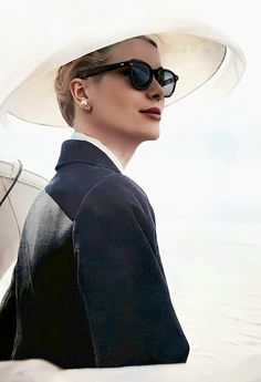 a woman wearing a white hat and sunglasses