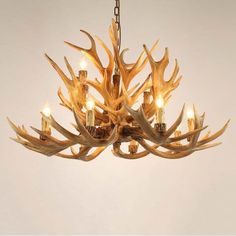 a chandelier with antlers hanging from it's center and four lights on each side