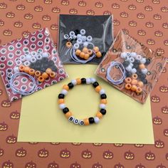 three halloween themed items sitting on top of a table next to some plastic bags and scissors