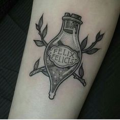 a black and white photo of a bottle with the words felix felicis on it