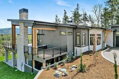 a modern home in the mountains with an outdoor deck