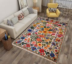 a living room filled with furniture and a colorful rug