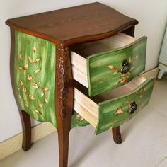 two drawers with flowers painted on them sit in front of a white wall and floor