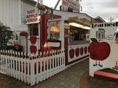 a red and white building with apples painted on it