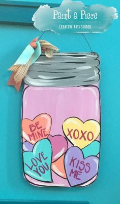 a painted mason jar with hearts on it