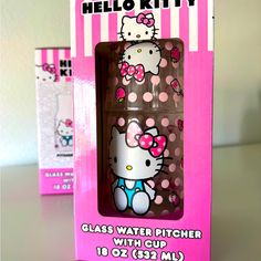 the hello kitty glass water pitcher is in its original box and it's pink with polka dots