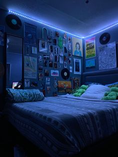 a bed in a room with lots of pictures on the wall and lights above it