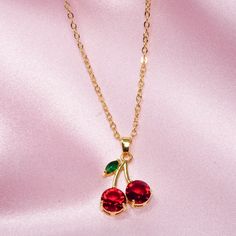 Cherry necklace  Good quality  Gold plated 14k  Brass Cherries are always a fresh, fruity, fun accessory to any style. These charming cherry necklaces make great gifts and are also lovely items to treat yourself with. They're a sweet summertime accessory that has great depth of color and shine. Cherry Colored Jewelry For Valentine's Day Party, Cherry Color Jewelry For Valentine's Day Party, Cherry Jewelry For Valentine's Day Party, Cherry-colored Jewelry For Valentine's Day Party, Trendy Gold Jewelry With Fruit Design, Trendy Summer Charm Necklaces As Gifts, Sweet Green Jewelry For Gifts, Trendy Red Jewelry With Fruit Design, Trendy Red Pendant Necklace