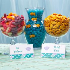 three glass bowls filled with different types of candy