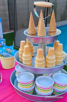 an ice cream stand with cones on it