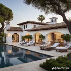 an outdoor pool with chaise lounges next to it