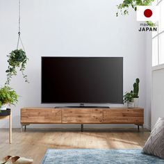 a flat screen tv sitting on top of a wooden entertainment center