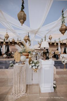 an outdoor event with white and gold decorations