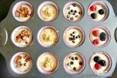 a muffin tin filled with cupcakes topped with fruit and nuts on top