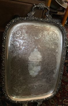 an ornate silver tray with a woman's face on it