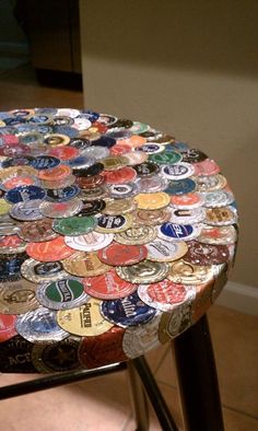 a chair made out of many different types of beer caps on it's seat