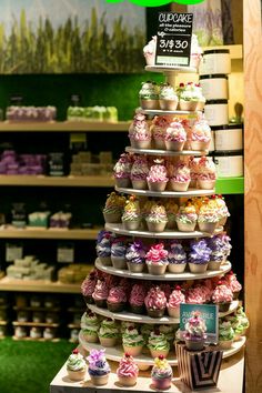 a display in a store filled with lots of cupcakes