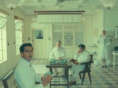 a group of men sitting around a table in a room