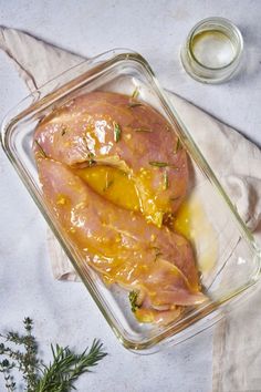 a glass casserole dish filled with ham and cheese on top of a table