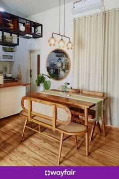 a dining room table with chairs and a mirror on the wall in front of it