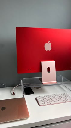 an apple computer sitting on top of a white desk