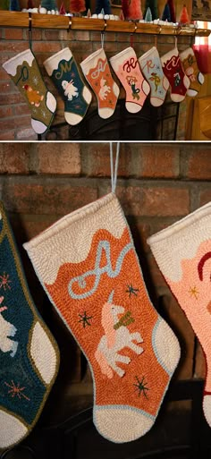 christmas stockings hanging from hooks in front of a fireplace